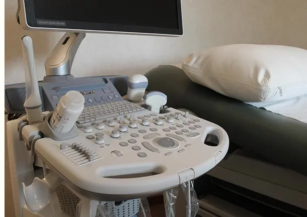 The ultrasound machine beside the examination bed